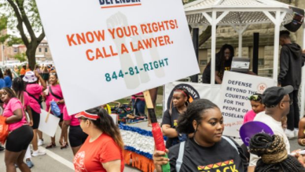 Protester holds a sign that says Know your rights - call a lawyer 