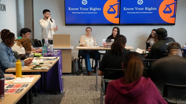 A man presents to a group of people at the Freedom Defense Center of Austin.