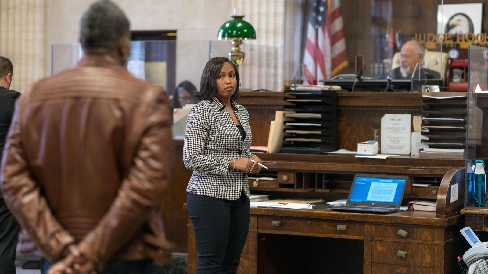 Assistant Public Defender consults with her client in a courtroom