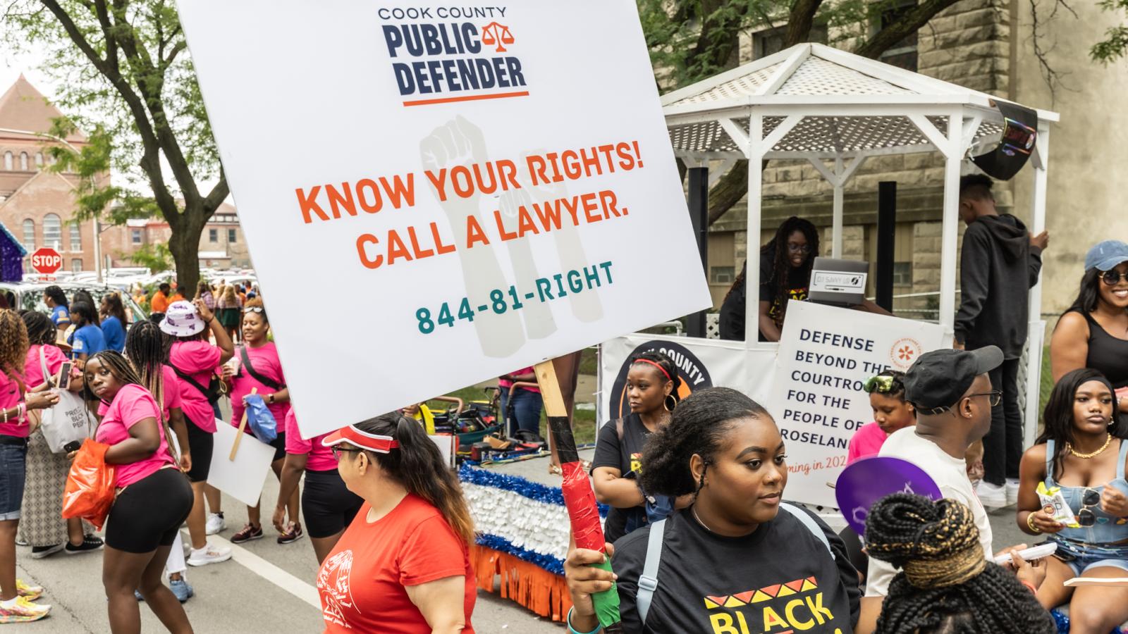 Public Defender staff carrying signs in 2023 Bud Billiken parade